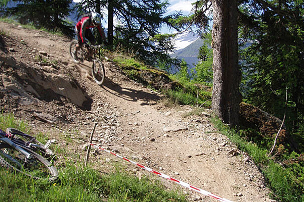 A person riding a bike down a dirt trail