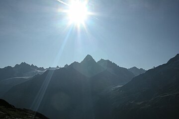 The sun is shining brightly over the mountains