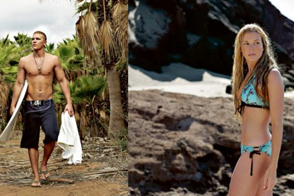 A man and a woman are standing next to each other on a beach