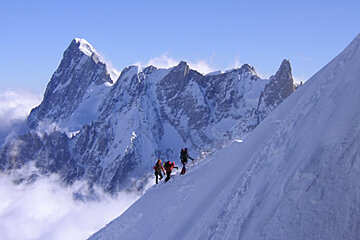 A group of people are hiking up a snowy mountain
