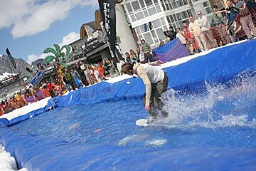 A man is riding a surfboard in a pool of water