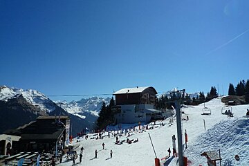 A group of people skiing down a snow covered slope