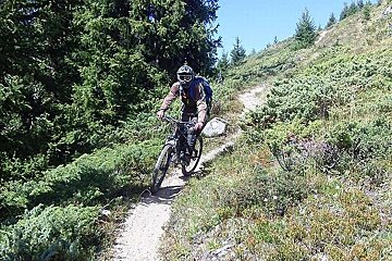 An image of a mountain biker on a trail in Verbier