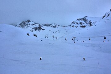 An image of snowboarders on a quiet run