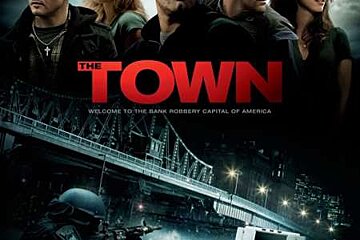 A movie poster for the town shows a group of people standing next to each other