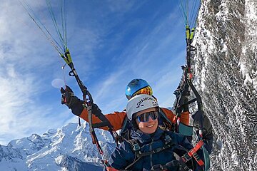 an image of a person taking off parapenting with a white sail