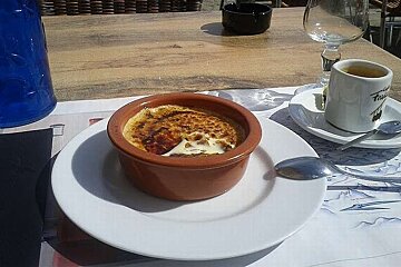 an image of a small dessert creme brulee with apples and a coffee