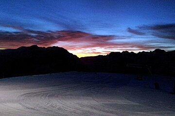 Sunset over mountains and empty piste