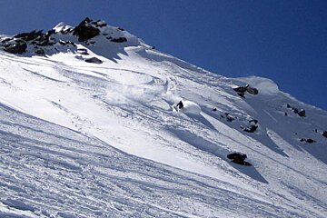 A person skiing down a snow covered mountain
