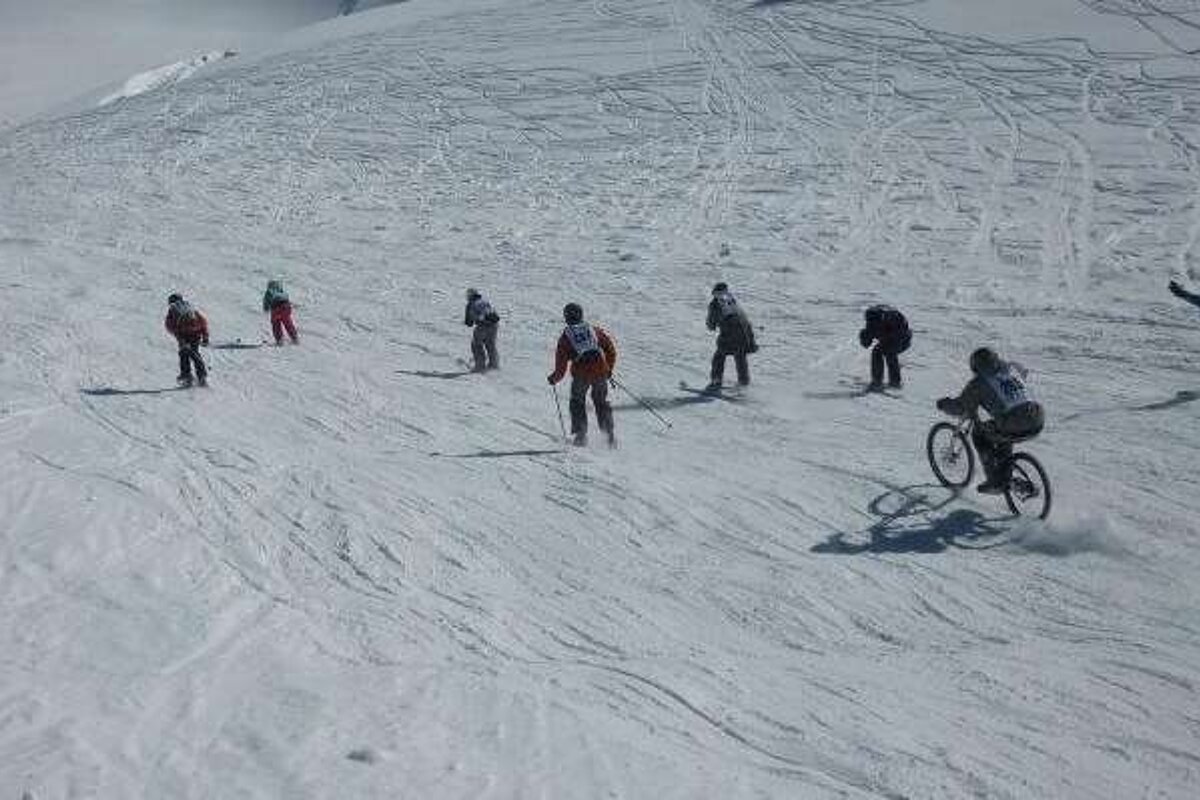Skier and biker on slope