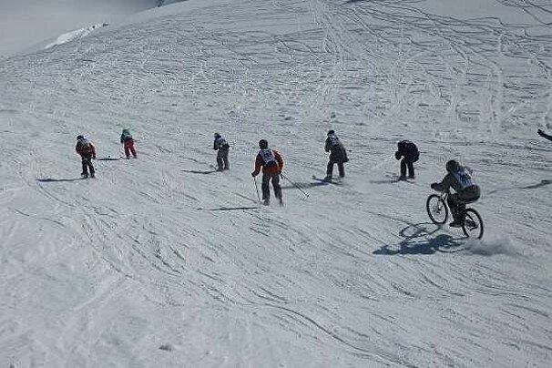 Skier and biker on slope