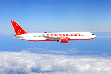 A globespan.com airplane is flying in the sky