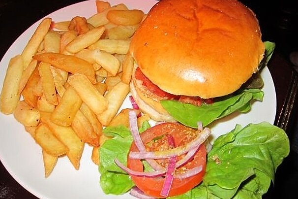 A white plate topped with a hamburger and french fries
