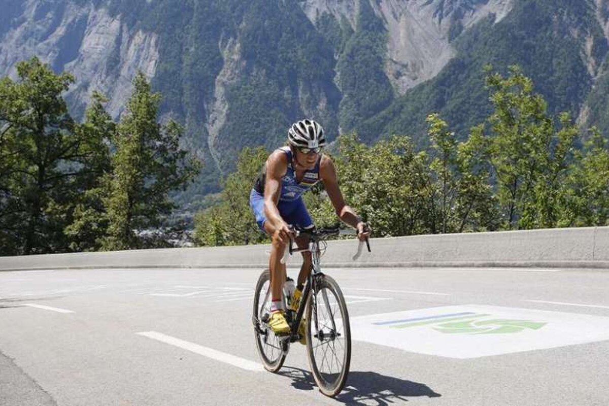 An image of a cyclist riding up the 21 bends as part of the Alpe d'Huez Triathlon