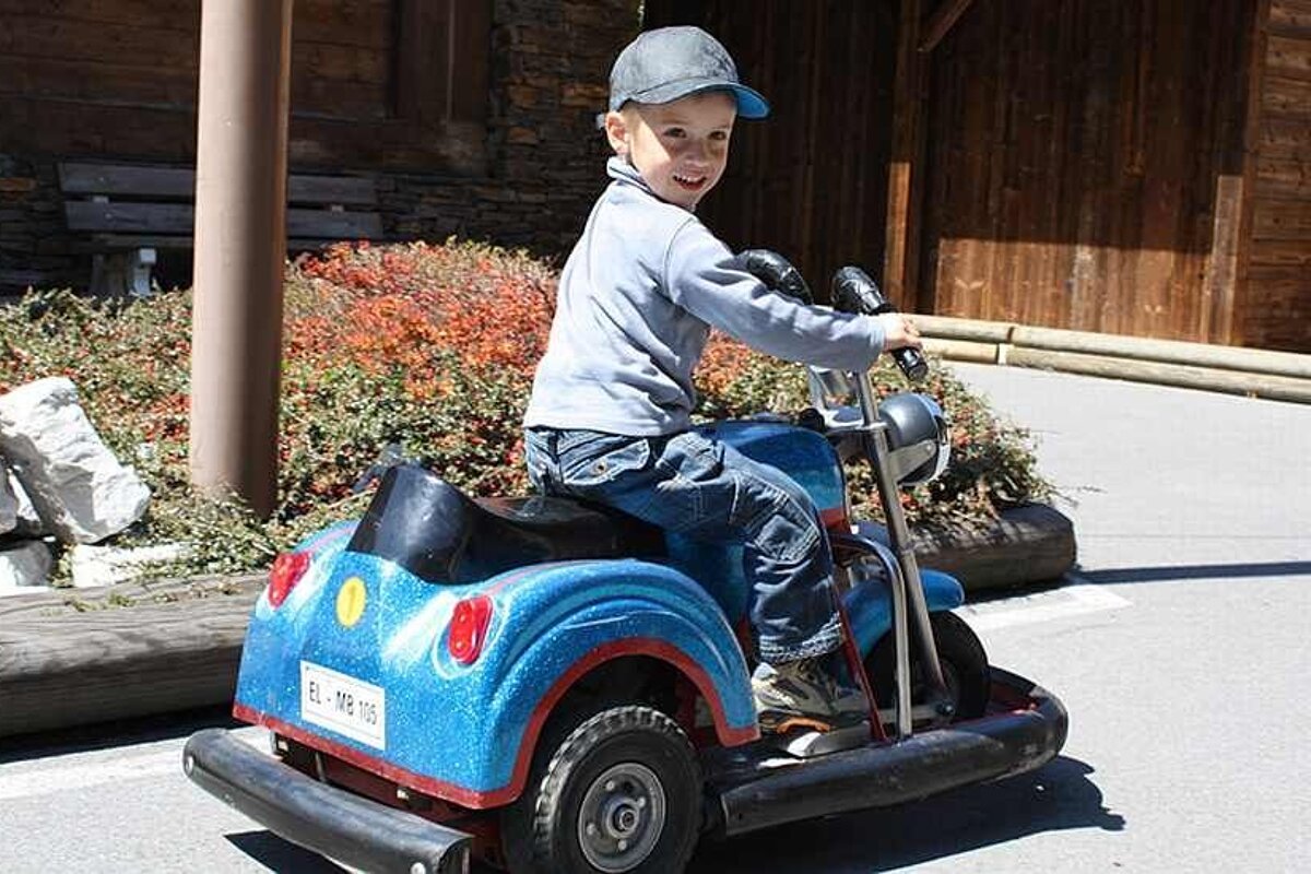 an image of a small kid on an electric motorbike