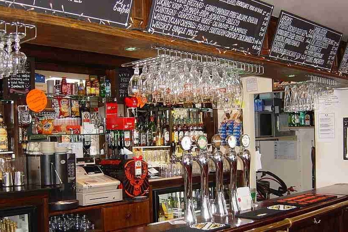 an image of a bar with chalk boards above showing the prices