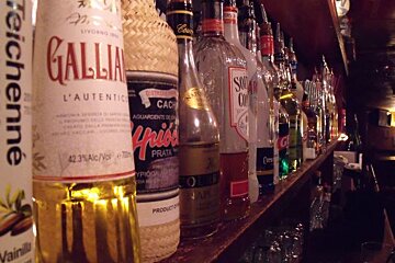 A bottle of gallia sits on a bar shelf