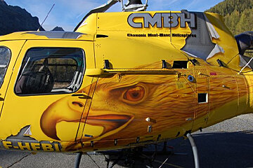 A yellow helicopter with the word cmbh on the side