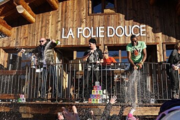 An image of the staff at La Folie Duce showering party-goers in champagne
