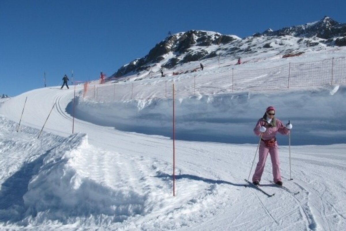 Cross country skier going down gentle path