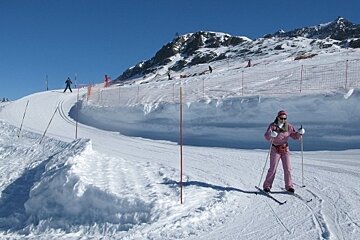Cross country skier going down gentle path
