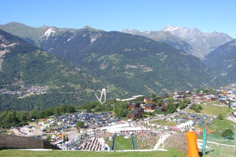 A view of a valley with mountains in the background