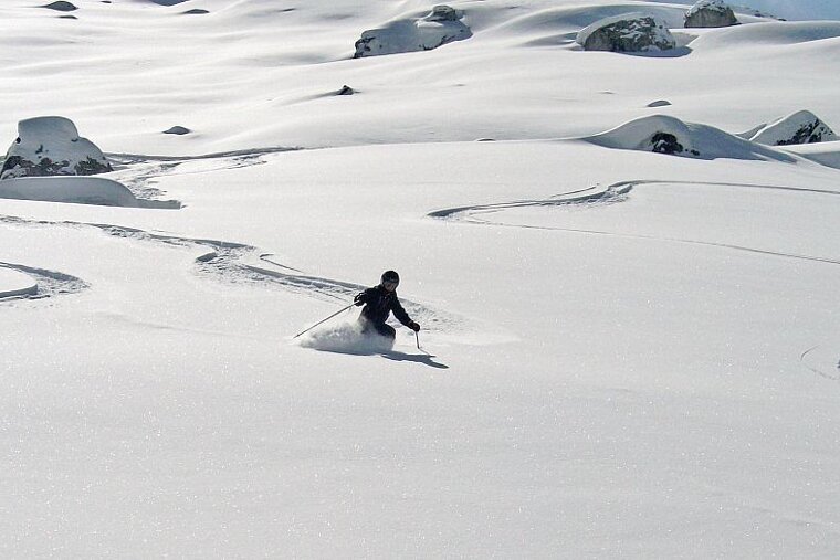 an image of a kid skiing off piste in deep snow