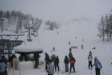 A group of people are skiing down a snow covered slope