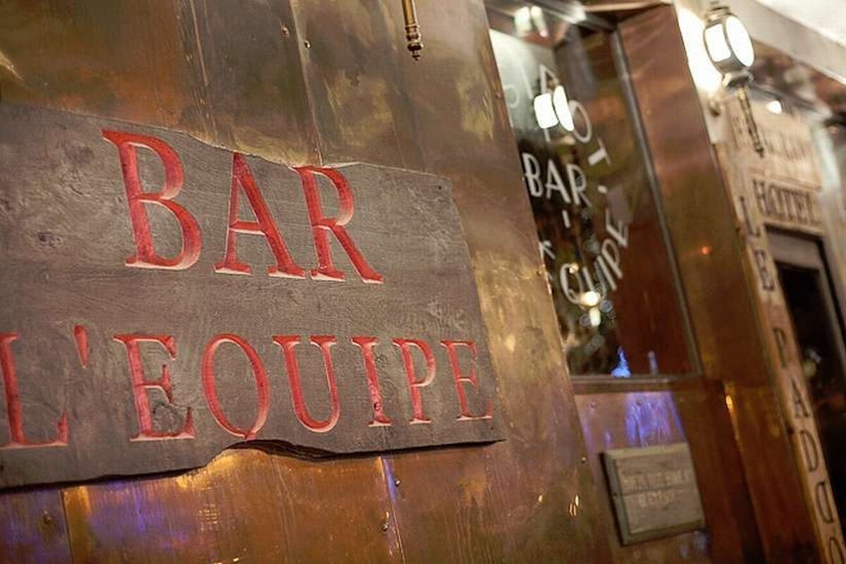 an image of a sign outside a bar on a wall showing the bars name