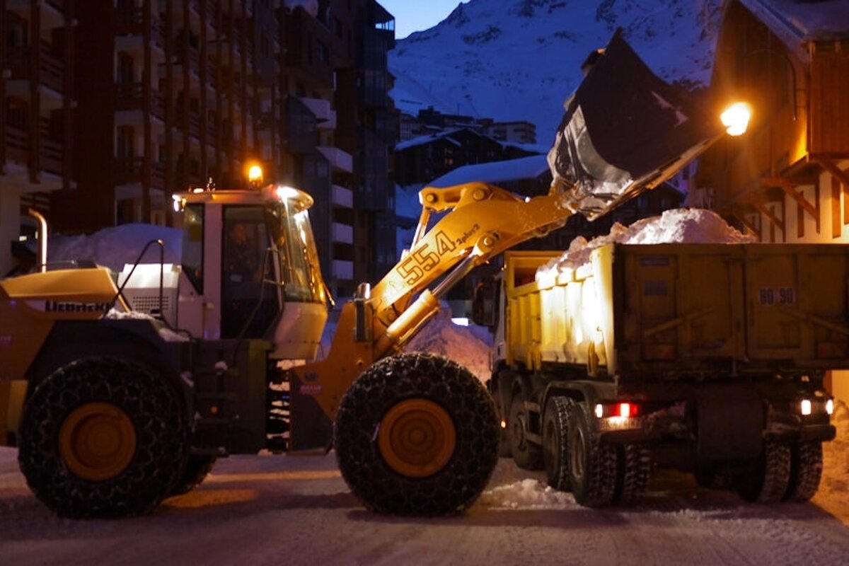 An image of a plough clearing away the last of the snow from the streets