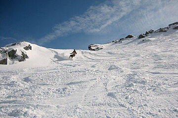 A person riding a horse down a snowy hill