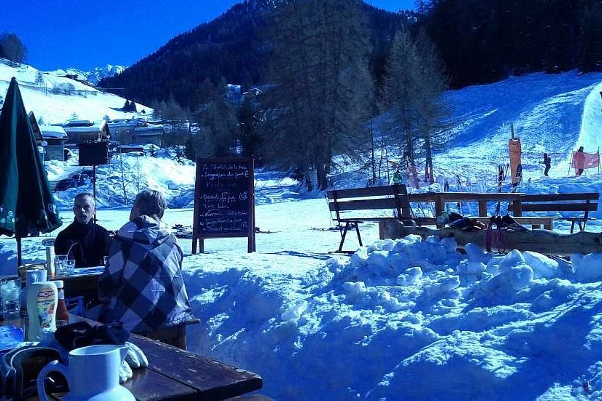 A snowy landscape with a sign that says
