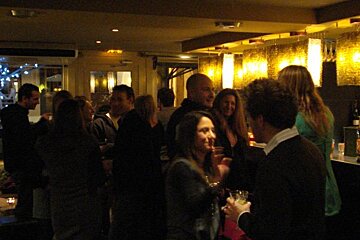 A group of people are gathered in a dark room