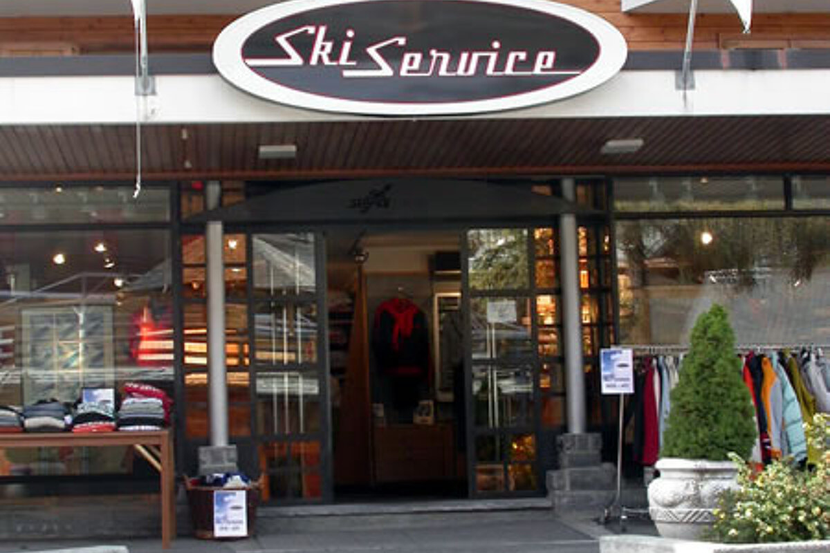 A ski service store front with stairs leading up to it
