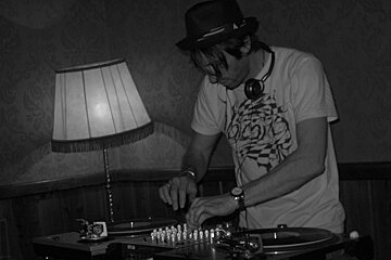 A man wearing headphones and a shirt that says ' icon ' on it