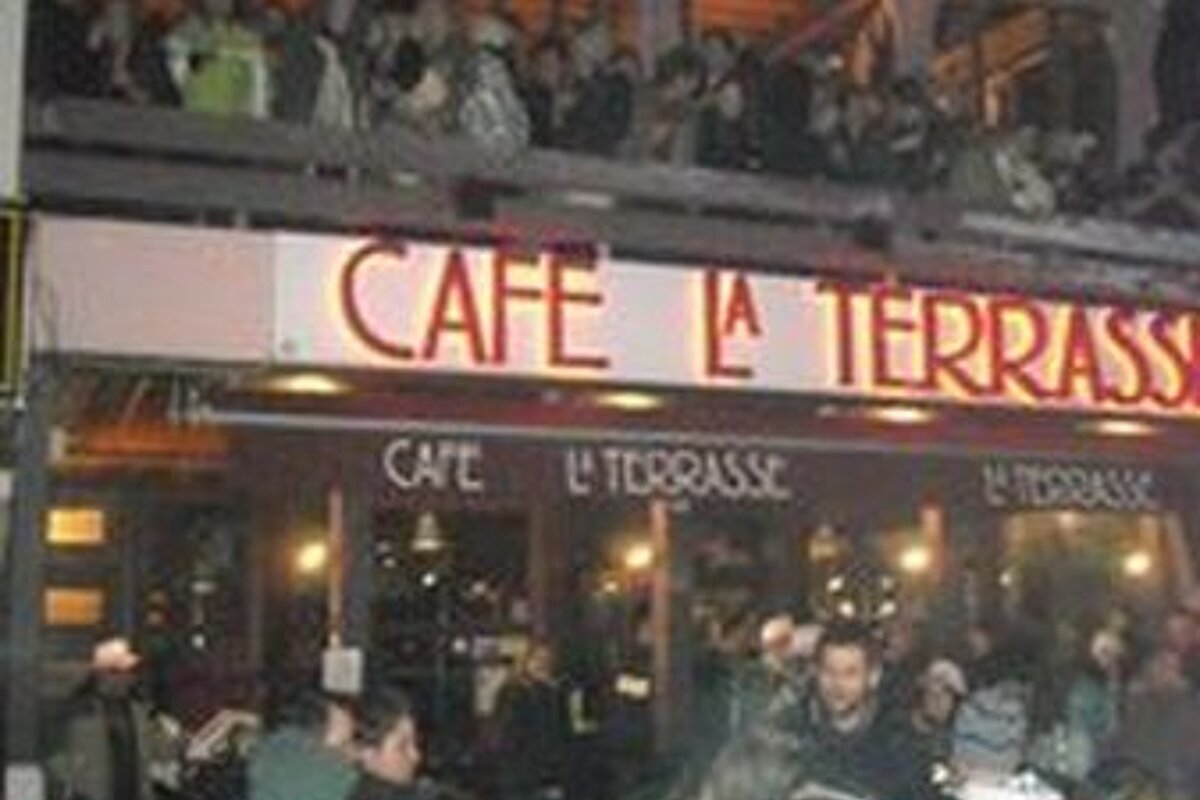 A crowd of people are gathered outside a restaurant called cafe la terrasse