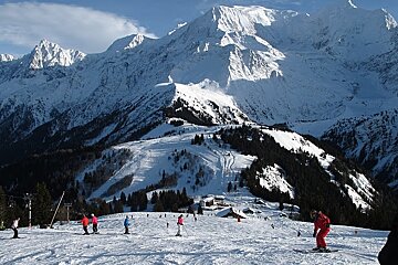 two boarders at base of piste