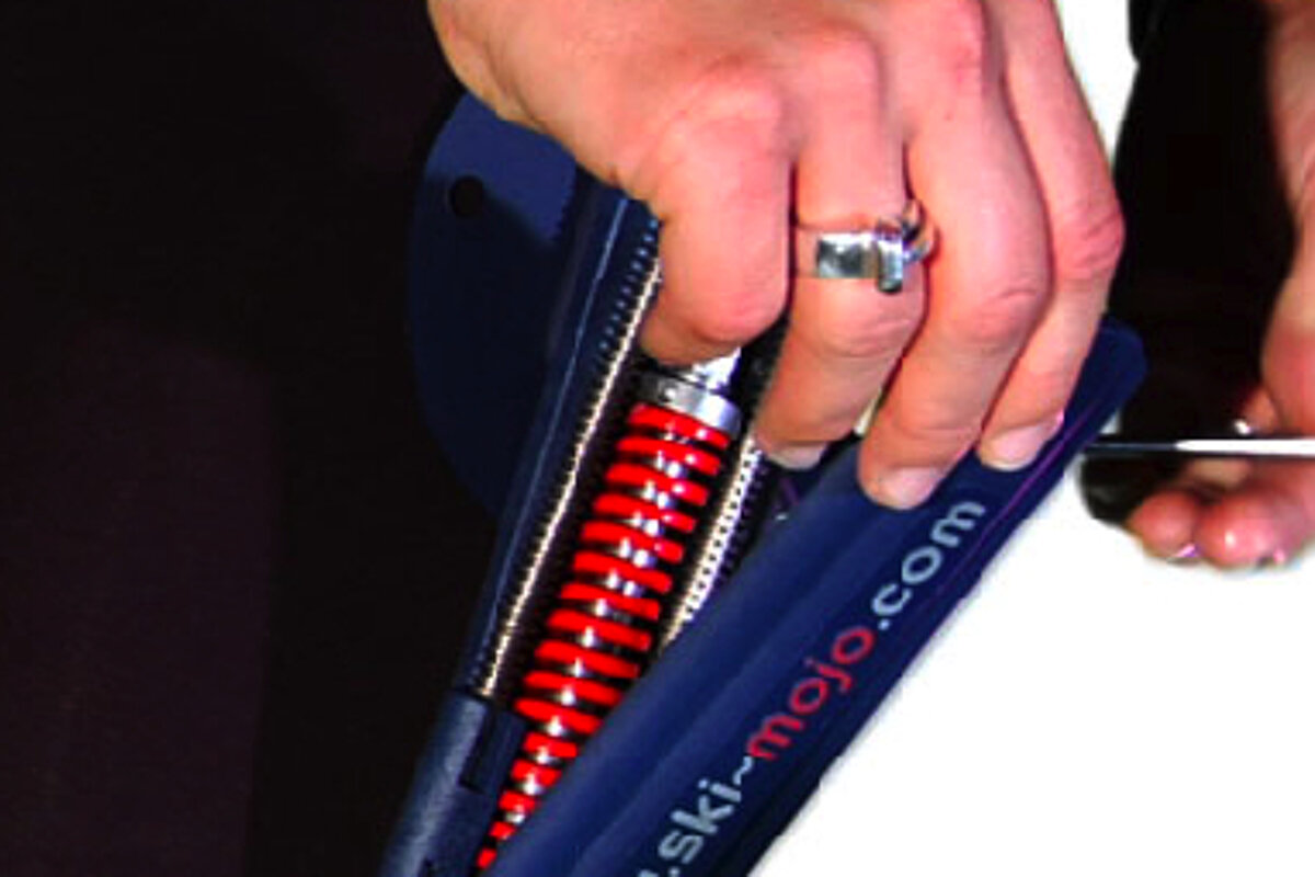 A person is holding a ski-mojo.com item in their hand