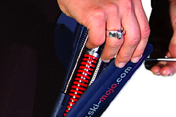 A person is holding a ski-mojo.com item in their hand