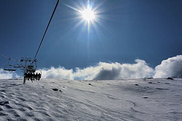 An image of the Moutiere chairlift and clouds on the horizon