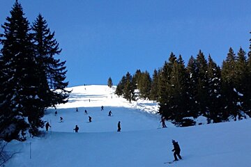 A group of people skiing down a snow covered slope