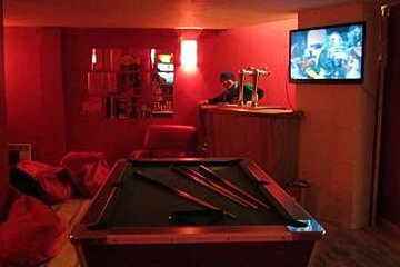 Downstairs you'll find comfy chairs, pool and bar