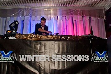 A man playing music at a winter sessions event
