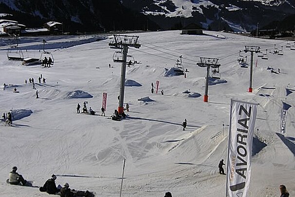 A snowy ski slope with a banner that says avoriaz