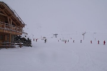 A group of people skiing down a snow covered slope