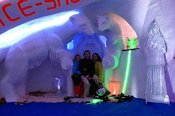 A group of people posing in front of a sign that says ice-show