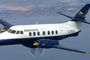 A blue and white airplane with the letters g-islc on the tail