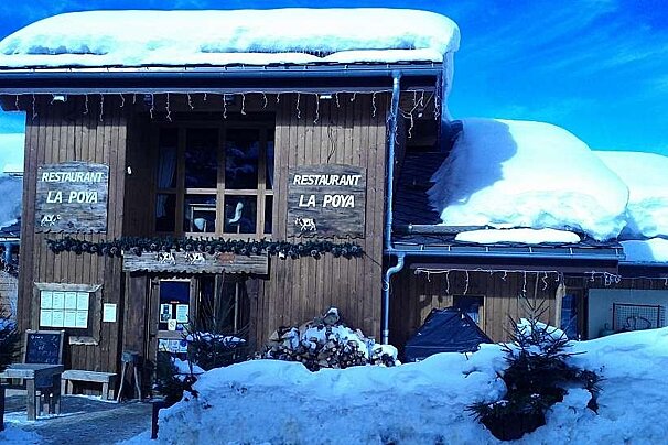 A restaurant called la poya is covered in snow