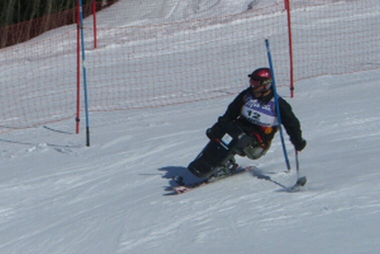 Adaptive handiski disabled skier taking part in a ski race