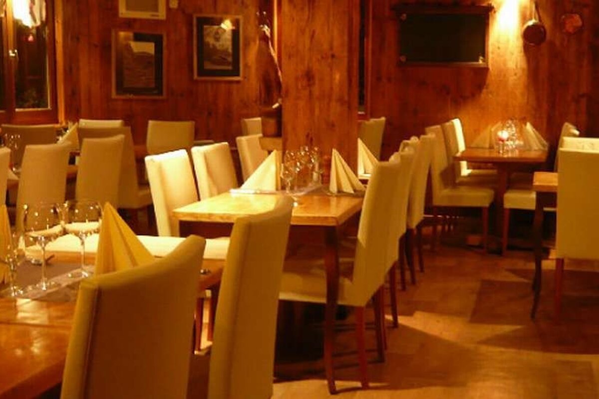 an image of a restaurant with lots of yellow tables and chairs in